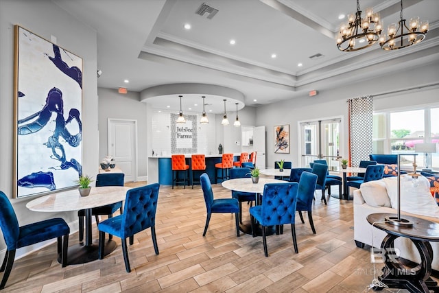 dining room with visible vents, a tray ceiling, french doors, and wood finish floors