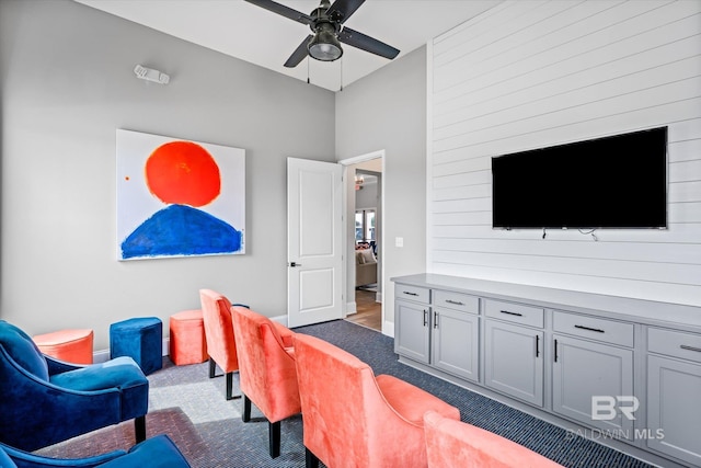 interior space with carpet floors and a ceiling fan