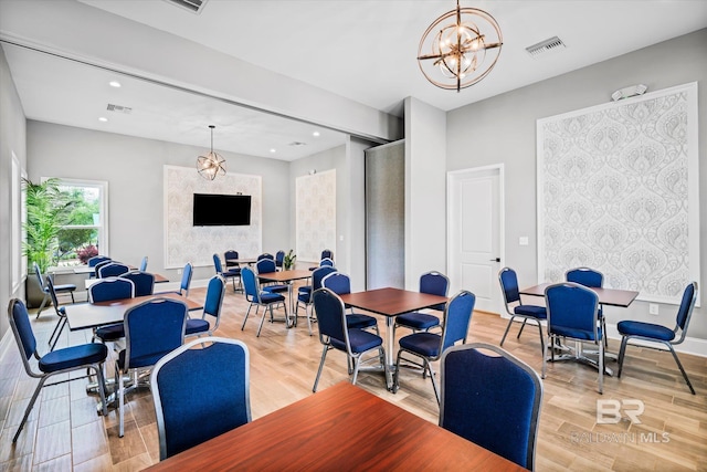 dining area with recessed lighting, visible vents, a notable chandelier, and light wood finished floors