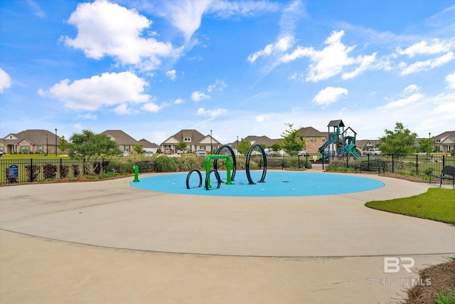 view of home's community with playground community, fence, and a residential view