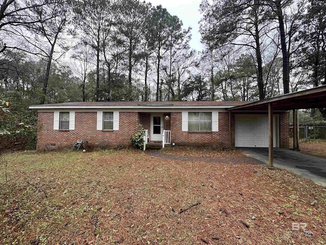 single story home featuring an attached carport, driveway, a garage, crawl space, and brick siding