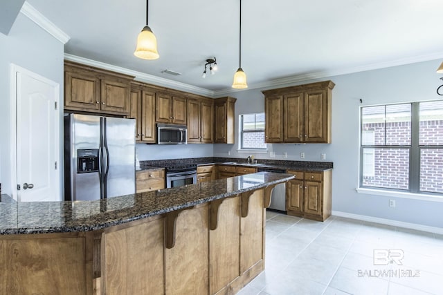 4005 Serene Ct, Foley, AL 36535 - kitchen featuring pendant lighting, a breakfast bar, ornamental molding, appliances with stainless steel finishes, and light tile patterned flooring