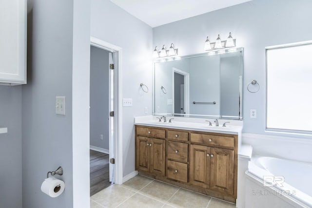 4005 Serene Ct, Foley, AL 36535 - full bath featuring a sink, a garden tub, double vanity, and tile patterned flooring