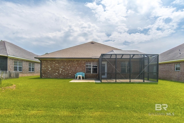 4005 Serene Ct, Foley, AL 36535 - rear view of house with a patio area, glass enclosure, a yard, and brick siding