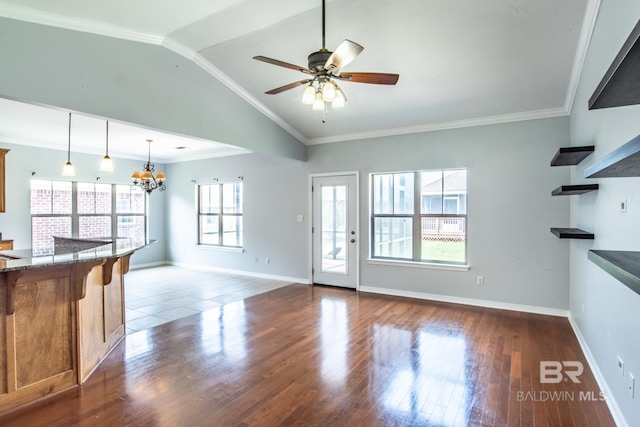 4005 Serene Ct, Foley, AL 36535 - unfurnished living room featuring wood finished floors, baseboards, ornamental molding, vaulted ceiling, and ceiling fan with notable chandelier