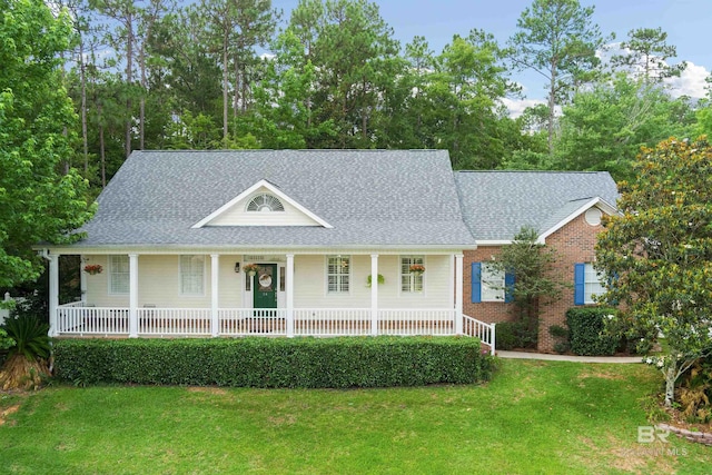 14 General Canby Dr, Spanish Fort, AL 36527 - view of front of property with a porch, a front yard, a shingled roof, and brick siding