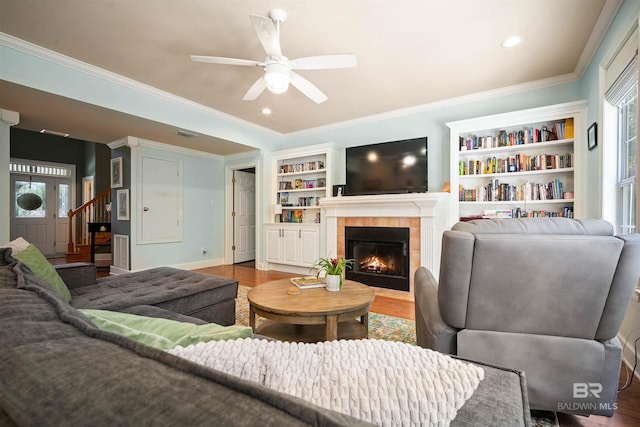 14 General Canby Dr, Spanish Fort, AL 36527 - living room with wood finished floors, a fireplace, ornamental molding, ceiling fan, and built in shelves