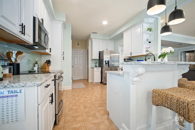 14 General Canby Dr, Spanish Fort, AL 36527 - kitchen featuring stainless steel appliances, white cabinets, open shelves, and backsplash