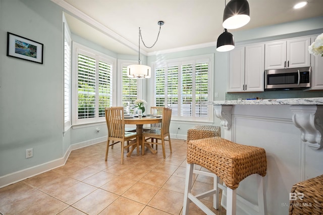14 General Canby Dr, Spanish Fort, AL 36527 - kitchen featuring stainless steel microwave, light tile patterned floors, plenty of natural light, white cabinets, and ornamental molding