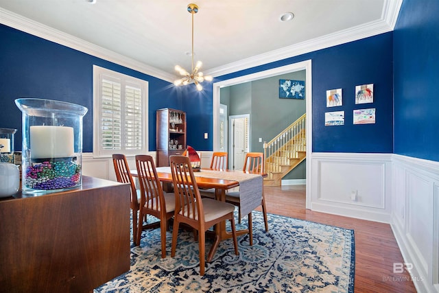 14 General Canby Dr, Spanish Fort, AL 36527 - dining area featuring a chandelier, crown molding, a wainscoted wall, wood finished floors, and stairway