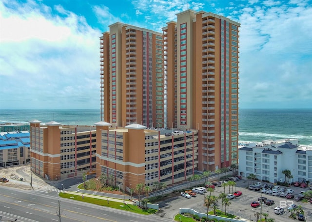 view of property featuring a water view and a view of city