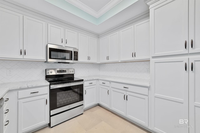 kitchen featuring white cabinets, decorative backsplash, appliances with stainless steel finishes, light stone counters, and ornamental molding