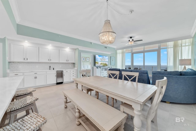 dining space featuring light tile patterned floors, ceiling fan with notable chandelier, and crown molding