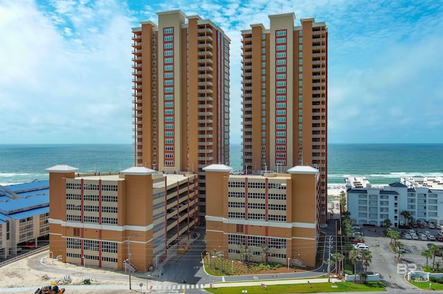 view of building exterior featuring a water view and a city view