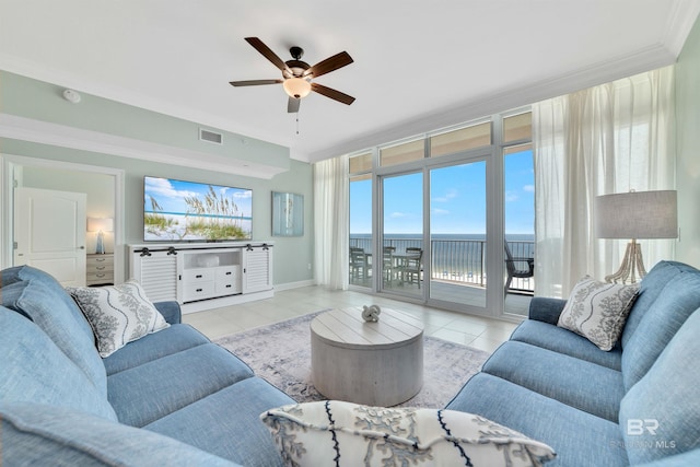 tiled living area featuring a ceiling fan, visible vents, crown molding, and baseboards