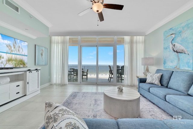 living room featuring light tile patterned floors, visible vents, a ceiling fan, ornamental molding, and a water view