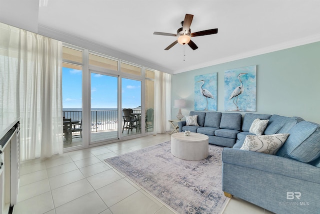 tiled living area featuring a water view, a ceiling fan, and crown molding