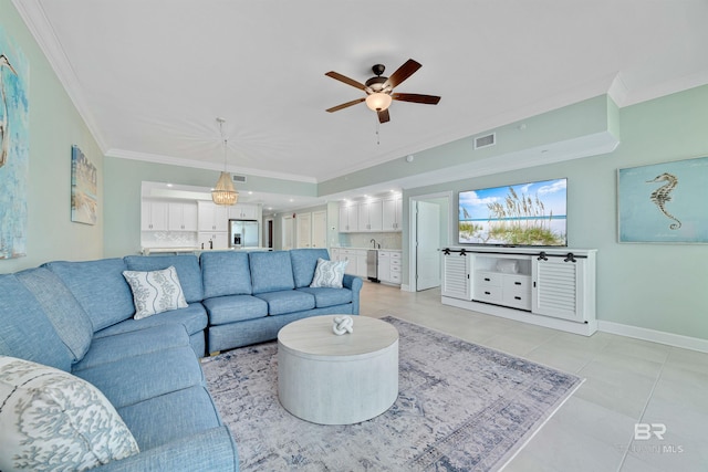 living area with ceiling fan, light tile patterned floors, visible vents, baseboards, and crown molding