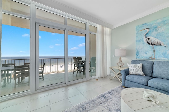 living area with a water view, crown molding, and tile patterned floors