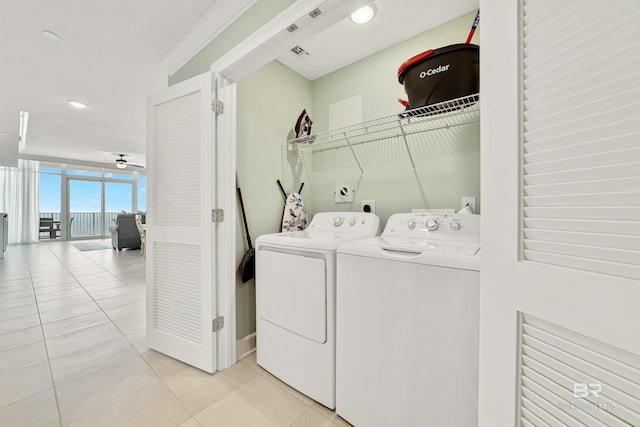 washroom featuring laundry area, visible vents, ceiling fan, washer and dryer, and light tile patterned flooring