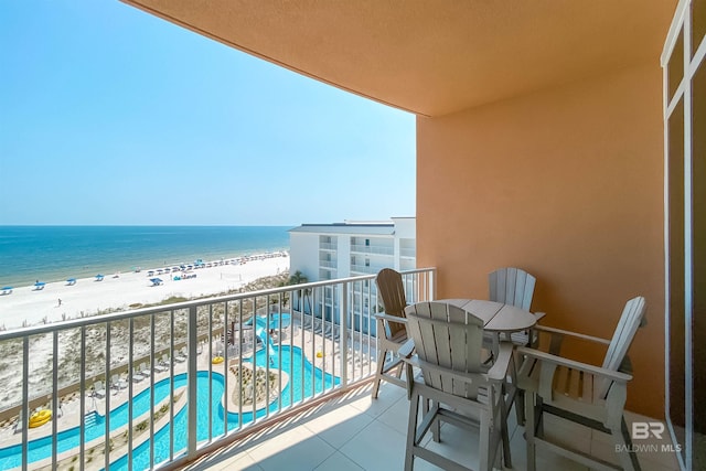 balcony featuring a water view and a beach view