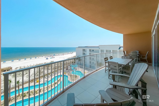 balcony with a water view and a beach view