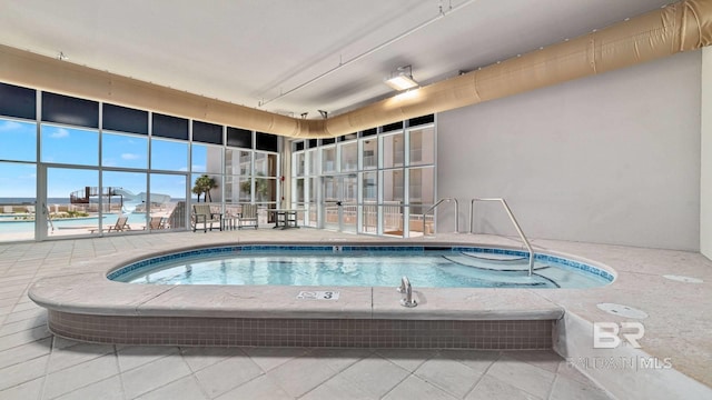 view of pool with an indoor hot tub