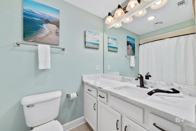 bathroom featuring baseboards, visible vents, vanity, and toilet