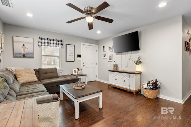 living room with ceiling fan and dark hardwood / wood-style flooring