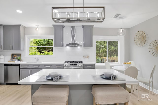 300 Indian Creek Dr, Mobile, AL 36607 - kitchen with gray cabinetry, appliances with stainless steel finishes, wall chimney range hood, a sink, and recessed lighting