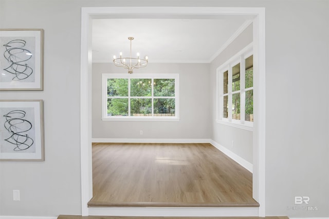 300 Indian Creek Dr, Mobile, AL 36607 - unfurnished dining area featuring crown molding, a chandelier, baseboards, and wood finished floors