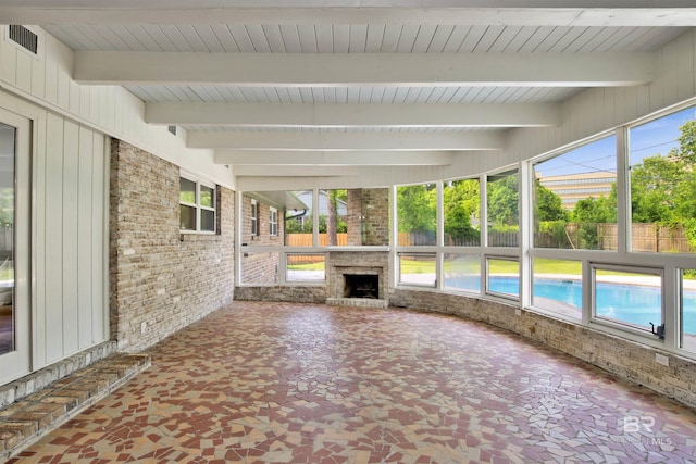 300 Indian Creek Dr, Mobile, AL 36607 - unfurnished sunroom featuring exterior fireplace, beamed ceiling, and plenty of natural light