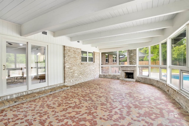 300 Indian Creek Dr, Mobile, AL 36607 - unfurnished sunroom with beam ceiling, plenty of natural light, and brick wall