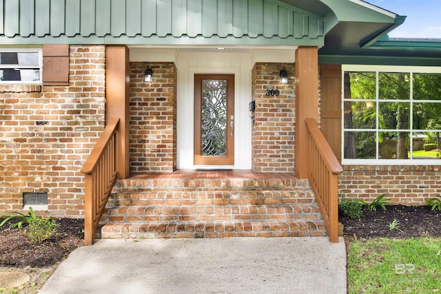 300 Indian Creek Dr, Mobile, AL 36607 - property entrance with brick siding, board and batten siding, a porch, and crawl space