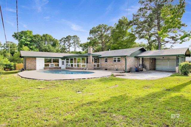 300 Indian Creek Dr, Mobile, AL 36607 - rear view of property with central air condition unit, a garage, brick siding, and a patio area