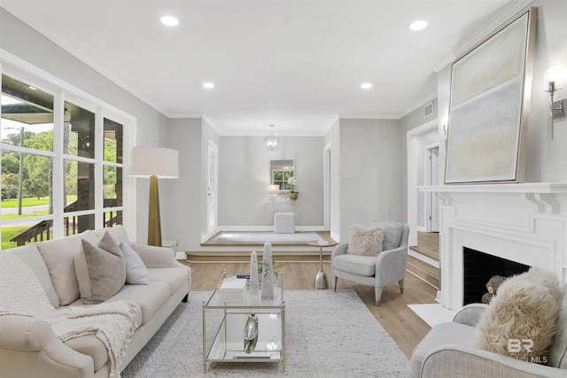 300 Indian Creek Dr, Mobile, AL 36607 - living room featuring plenty of natural light, light wood-type flooring, recessed lighting, a fireplace with flush hearth, and crown molding