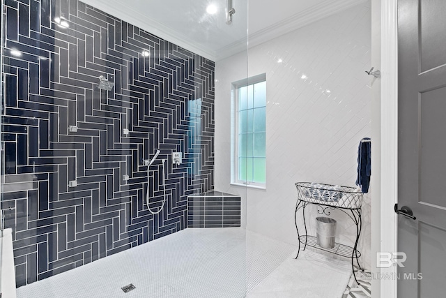 bathroom featuring a tile shower and crown molding