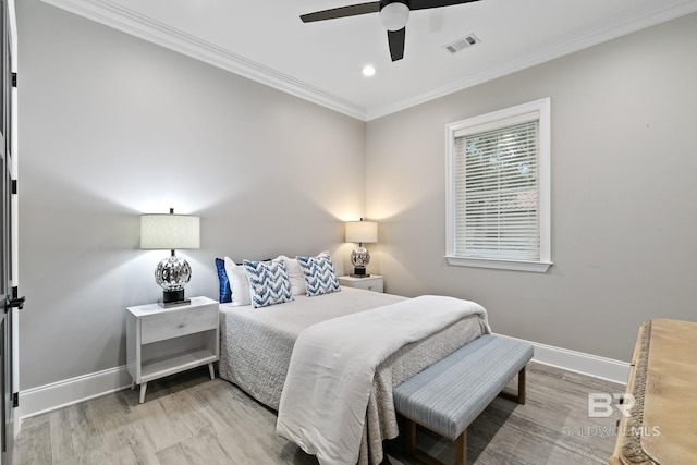 bedroom featuring ornamental molding, light hardwood / wood-style floors, and ceiling fan