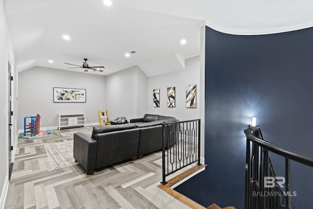 living room featuring ceiling fan, vaulted ceiling, and light parquet floors