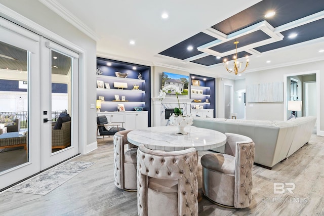 dining area featuring coffered ceiling, light hardwood / wood-style floors, crown molding, an inviting chandelier, and french doors