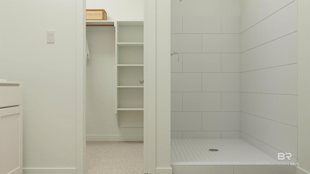 full bath featuring baseboards and a shower stall