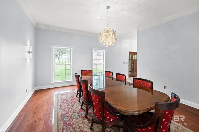 dining room featuring hardwood / wood-style flooring, crown molding, and a chandelier