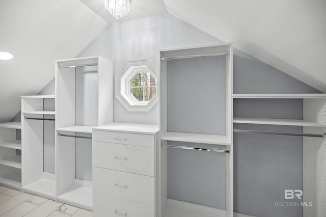 walk in closet with light tile patterned flooring and lofted ceiling