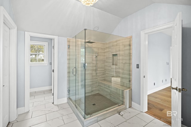 bathroom with tile patterned floors, lofted ceiling, and a shower with shower door