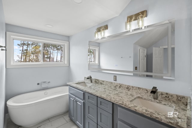 bathroom featuring tile patterned flooring, lofted ceiling, a bathtub, and double sink vanity