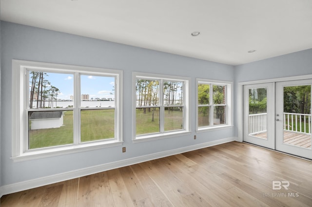 unfurnished sunroom with plenty of natural light and french doors