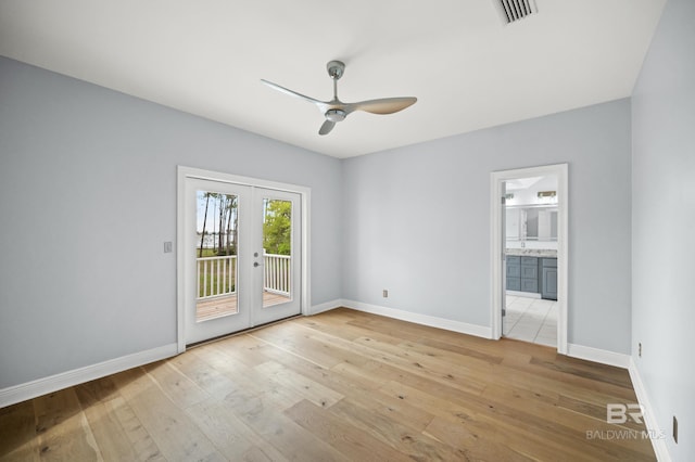 empty room with ceiling fan, french doors, and light hardwood / wood-style floors