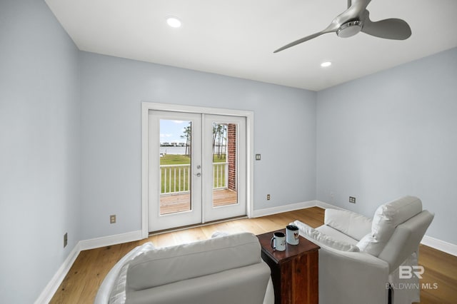 living room with ceiling fan, light wood-type flooring, and french doors