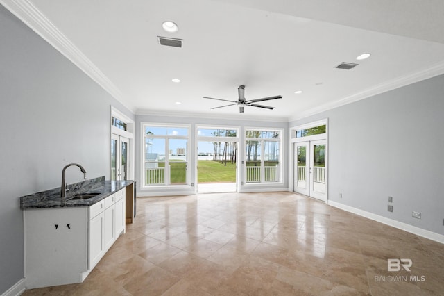 kitchen with light tile patterned floors, sink, plenty of natural light, and french doors