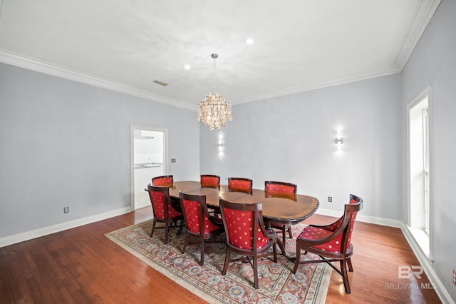 dining area with ornamental molding, a notable chandelier, and wood-type flooring